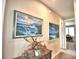 Bright hallway with artwork and decorative console table at 113 Pecorri Ct, Auburndale, FL 33823