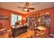 Spacious home office features built-in shelving, hardwood floors, and a ceiling fan at 113 Pecorri Ct, Auburndale, FL 33823