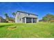 Two-story house with a large screened-in porch and a spacious backyard at 113 Pecorri Ct, Auburndale, FL 33823
