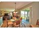 Open floor plan with dining area leading to a screened lanai overlooking a pond at 113 Pecorri Ct, Auburndale, FL 33823