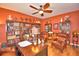 Well-appointed office with built-in bookshelves and cozy leather chairs at 113 Pecorri Ct, Auburndale, FL 33823