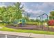 Community playground with playset, swings, and ample green space at 113 Pecorri Ct, Auburndale, FL 33823