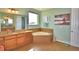 Primary bathroom with corner soaking tub and double vanity at 113 Pecorri Ct, Auburndale, FL 33823