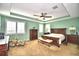 Spacious Primary bedroom with a king-size bed and large windows at 113 Pecorri Ct, Auburndale, FL 33823