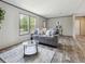 Living room with gray couch and view of kitchen at 11466 Nw 8Th Pl, Ocala, FL 34482