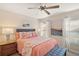 Cozy bedroom with coral bedding and ceiling fan at 11579 Se 172Nd Loop, Summerfield, FL 34491