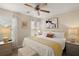 Main bedroom with yellow bedding and ceiling fan at 11579 Se 172Nd Loop, Summerfield, FL 34491