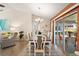 Dining room with wood table, white chairs, and access to a screened patio at 11579 Se 172Nd Loop, Summerfield, FL 34491