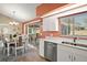 Kitchen with white cabinets, stainless steel appliances, and coral walls at 11579 Se 172Nd Loop, Summerfield, FL 34491