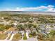 Aerial view of homes in a neighborhood with mature trees and manicured lawns in a tranquil lakeside setting at 11744 Oswalt Rd, Clermont, FL 34711