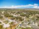 Aerial view of a neighborhood featuring cozy homes, pools, and tree-lined streets in a quiet residential area at 11744 Oswalt Rd, Clermont, FL 34711