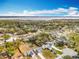 An aerial view features homes with manicured lawns and backyards, near the water at 11744 Oswalt Rd, Clermont, FL 34711