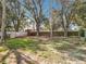 Large backyard featuring a mix of shade trees and lawn at 11744 Oswalt Rd, Clermont, FL 34711