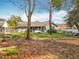 Large backyard featuring a screened in porch and a partially fenced yard with mature trees and falling leaves at 11744 Oswalt Rd, Clermont, FL 34711