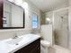 Bathroom with a modern vanity, toilet, and glass-enclosed shower at 11744 Oswalt Rd, Clermont, FL 34711