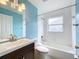 Well-lit bathroom featuring a tub-shower combo, a white sink, and chrome hardware at 11744 Oswalt Rd, Clermont, FL 34711