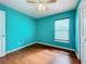 Bedroom featuring sleek wood-look flooring, a ceiling fan, a closet, and a window with blinds at 11744 Oswalt Rd, Clermont, FL 34711