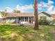 Rear exterior view of the house showing yard, back porch and patio area at 11744 Oswalt Rd, Clermont, FL 34711