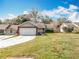 Charming one-story home with a well-maintained lawn and a two-car garage at 11744 Oswalt Rd, Clermont, FL 34711