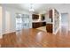 View of the kitchen, featuring wood cabinets, sleek countertops, and sliding doors leading to a sunroom at 11744 Oswalt Rd, Clermont, FL 34711