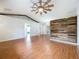 Large living room boasting wood-look floors, modern ceiling fan, and accent wall at 11744 Oswalt Rd, Clermont, FL 34711