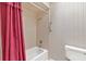 Bathroom featuring a shower and toilet, with a pink curtain at 1320 Cove Pl, Tavares, FL 32778