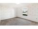 Bedroom with neutral carpet, a window, and floral wallpaper offers a cozy space at 1320 Cove Pl, Tavares, FL 32778