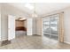 Bright dining room features sliding glass doors and entry to a room with wood paneled walls at 1320 Cove Pl, Tavares, FL 32778