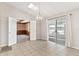 Bright dining room features sliding glass doors and entry to a room with wood paneled walls at 1320 Cove Pl, Tavares, FL 32778