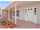 Charming front porch with white columns, decorative plants, and a well-lit entrance, creating a welcoming appeal at 1320 Cove Pl, Tavares, FL 32778