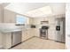 Bright kitchen with stainless steel appliances, plenty of counter space, and a view from the window at 1320 Cove Pl, Tavares, FL 32778