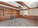 Living room with wood paneled walls, fireplace and ceiling fan at 1320 Cove Pl, Tavares, FL 32778