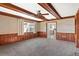 Living room with wood paneled walls, fireplace and ceiling fan at 1320 Cove Pl, Tavares, FL 32778