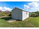 Exterior view of a shed, built in the backyard with a small window and a ramp to enter at 1320 Cove Pl, Tavares, FL 32778