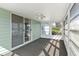 Relaxing sunroom with large windows and sliding glass door, perfect for enjoying the outdoors indoors at 1320 Cove Pl, Tavares, FL 32778