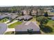 Aerial view of home showcasing landscaping, mature trees, and overall curb appeal at 13914 Se 96Th Cir, Summerfield, FL 34491