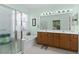 Well-lit main bathroom featuring double sinks, a soaking tub, and a separate shower at 13914 Se 96Th Cir, Summerfield, FL 34491