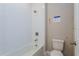 Clean bathroom with white subway tiles, bathtub, and toilet at 14261 Crest Palm Ave, Windermere, FL 34786