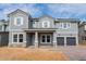 Two-story home with gray siding and a three-car garage at 14261 Crest Palm Ave, Windermere, FL 34786