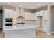 Modern kitchen with white cabinets, quartz countertops, and stainless steel appliances at 14261 Crest Palm Ave, Windermere, FL 34786