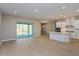 Modern kitchen with white cabinets, island, and access to the backyard at 14261 Crest Palm Ave, Windermere, FL 34786