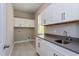 Laundry room with white cabinets and gray countertops at 14261 Crest Palm Ave, Windermere, FL 34786