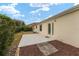 Backyard view showing a concrete patio and surrounding hedges at 1514 Vandam St, The Villages, FL 32162