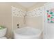 Corner bathtub with tile shower surround at 1514 Vandam St, The Villages, FL 32162