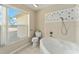 Bathroom featuring a bathtub, shower, and window at 1514 Vandam St, The Villages, FL 32162