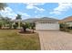 Single-story home with a paved driveway and landscaped lawn at 1514 Vandam St, The Villages, FL 32162