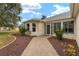 Welcoming front entry with a walkway and landscaping at 1514 Vandam St, The Villages, FL 32162