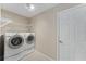 Laundry room with washer, dryer, and shelving at 1514 Vandam St, The Villages, FL 32162