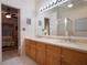 Double vanity bathroom with a view into a bedroom at 15729 Greater Groves Blvd, Clermont, FL 34714