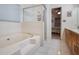 Clean bathroom with a bathtub, shower, and double vanity at 15729 Greater Groves Blvd, Clermont, FL 34714